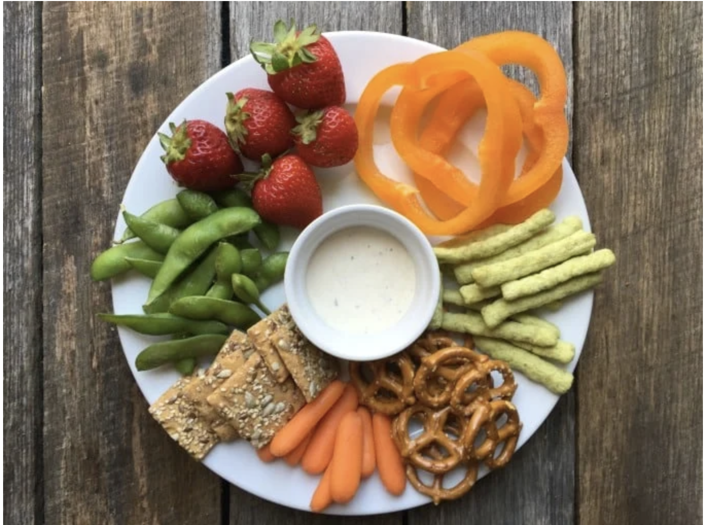 Easy & healthy toddler snack platter with cheese cubes, crackers, and fruit, served in a muffin tin for a fun and nutritious snack