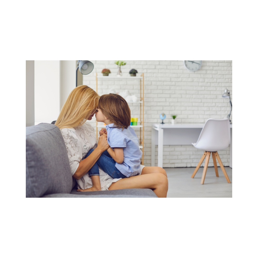 Parent reading a book about parenting strategies with a child nearby.